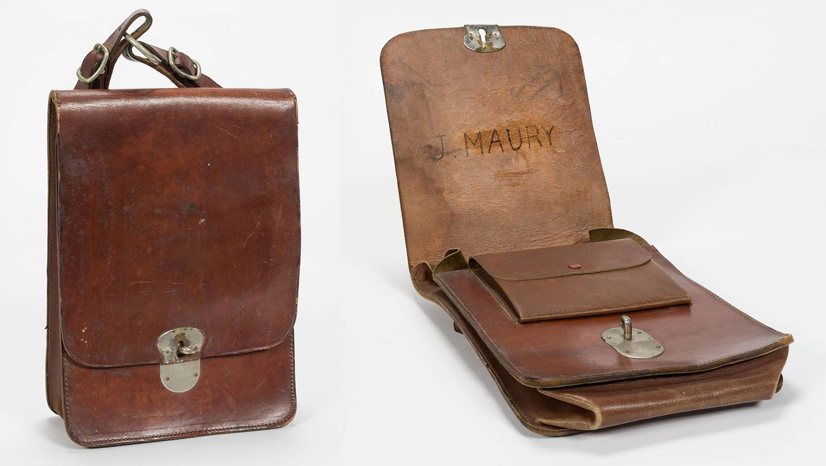 Vintage brown leather satchel with metal clasp, shown closed from the front, strap visible on top left.